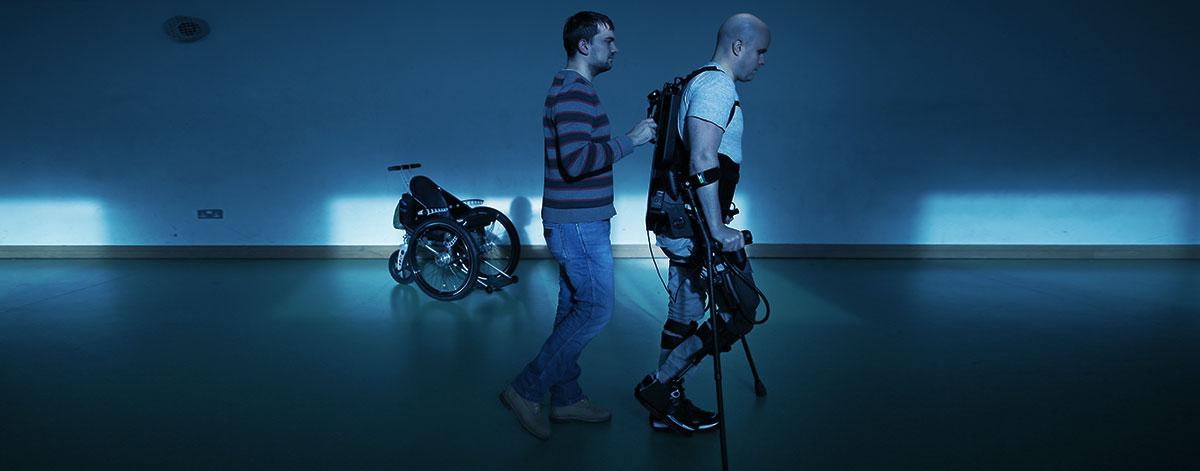 A picture of Mark walking in Ekso Bionics robotic legs in Trinity College Dublin