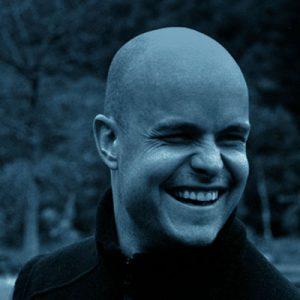 Portrait image in blue and white of Mark Pollock taken before he broke his back while training in Glendalough