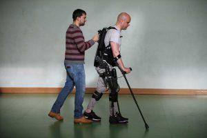 A picture of Mark walking in Ekso Bionics robotic legs in Trinity College Dublin